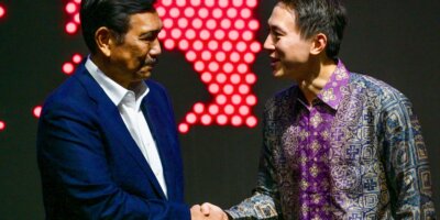 TikTok CEO Shou Zi Chew (R) shakes hands with Indonesian Coordinating Minister for Maritime Affairs and Investment Luhut Binsar Pandjaitan during the TikTok Southeast Asia Impact Forum 2023 in Jakarta, Indonesia on June 15, 2023. (Photo by BAY ISMOYO / AFP)