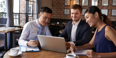 business colleagues discussing information on laptop